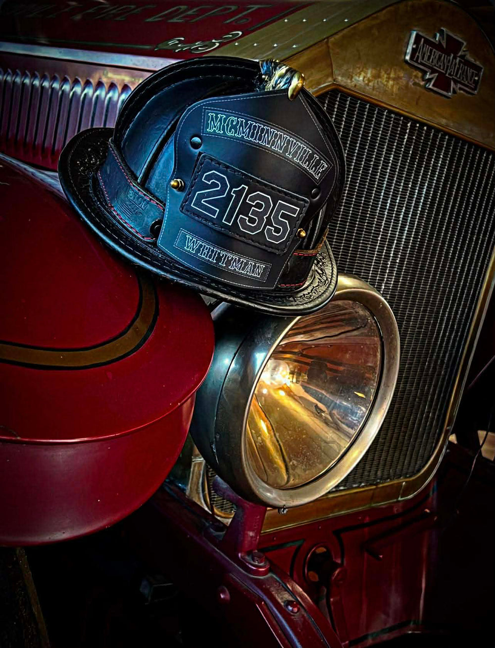A Box 31 traditional-style passport shield is featured sitting on the front of an antique American LaFrance engine in McMinnville.