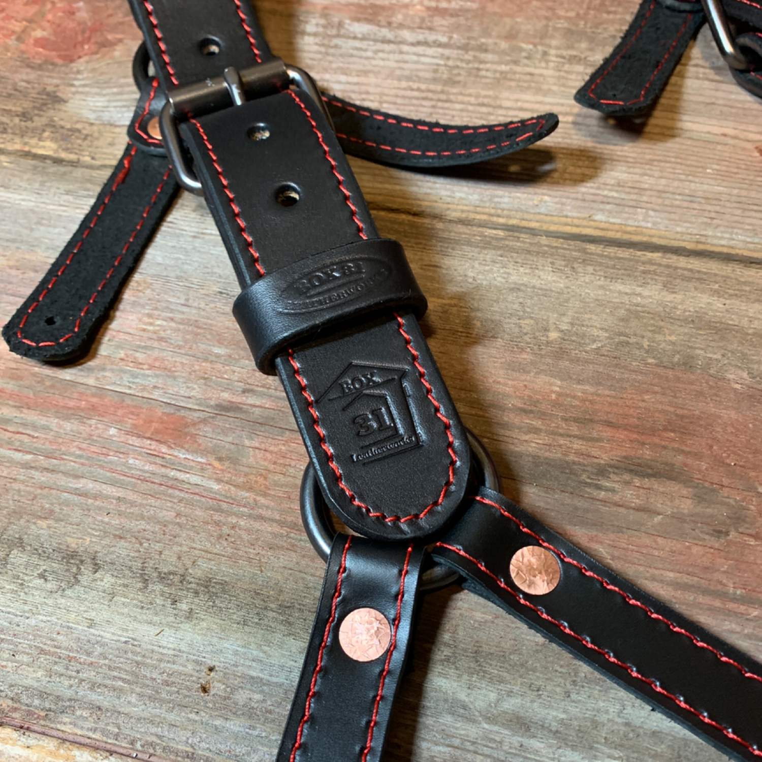 Detail of button-style attachment for Box 31's leather suspenders